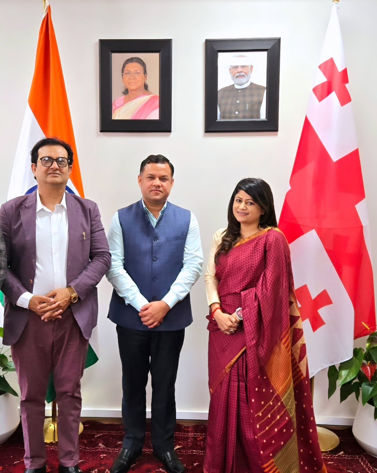 Parul Mahajan with officials beneath the portraits of the President and Prime Minister of India