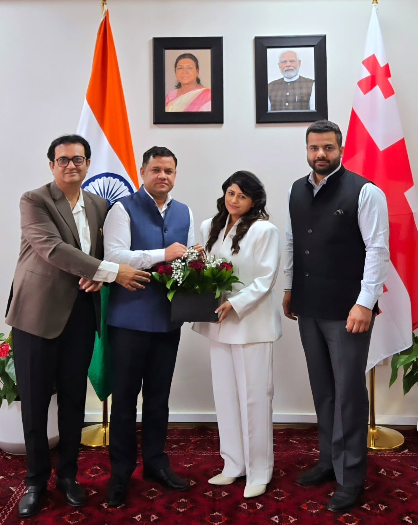 Parul Mahajan receiving flowers at the Embassy of India, Tbilisi, with Indian and Georgian flags